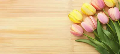 Bouquet Of Pink And Yellow Tulips On Wooden Background