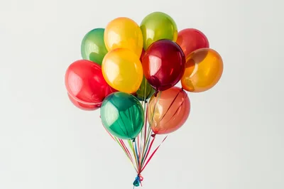 Bunch of Colorful Helium Balloons Against White Background