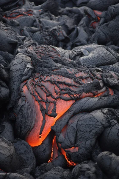 Molten Lava Flowing Over Hardened Volcanic Rock