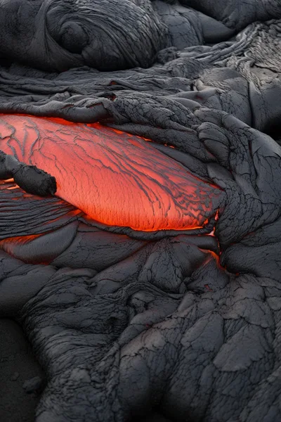 Molten Lava Flowing Over Hardened Volcanic Rock