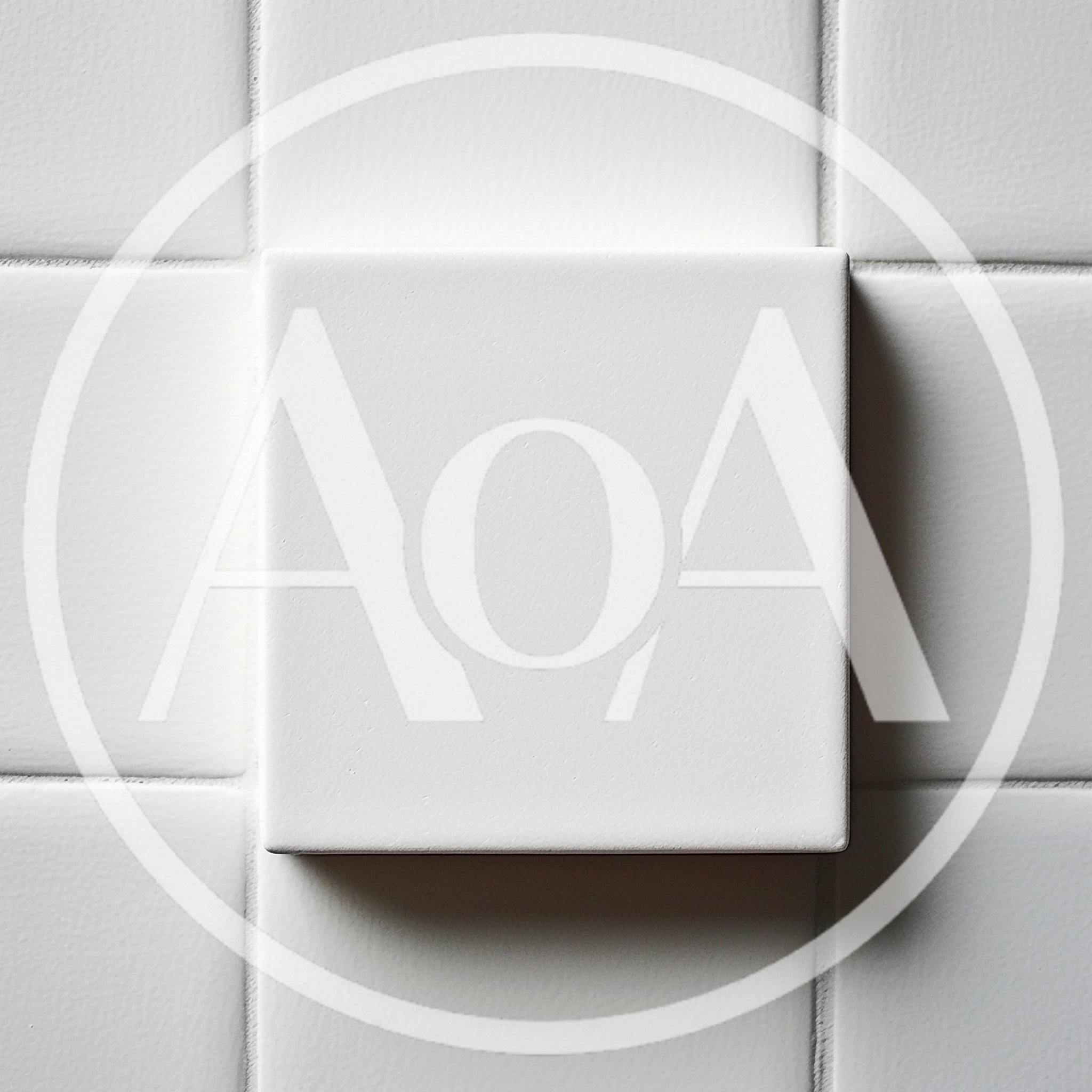 White Square Tile Floating Over Tiled Wall