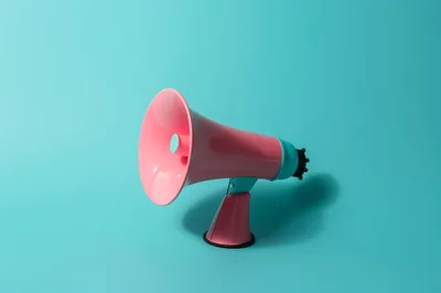 Pink Megaphone Standing On A Teal Background