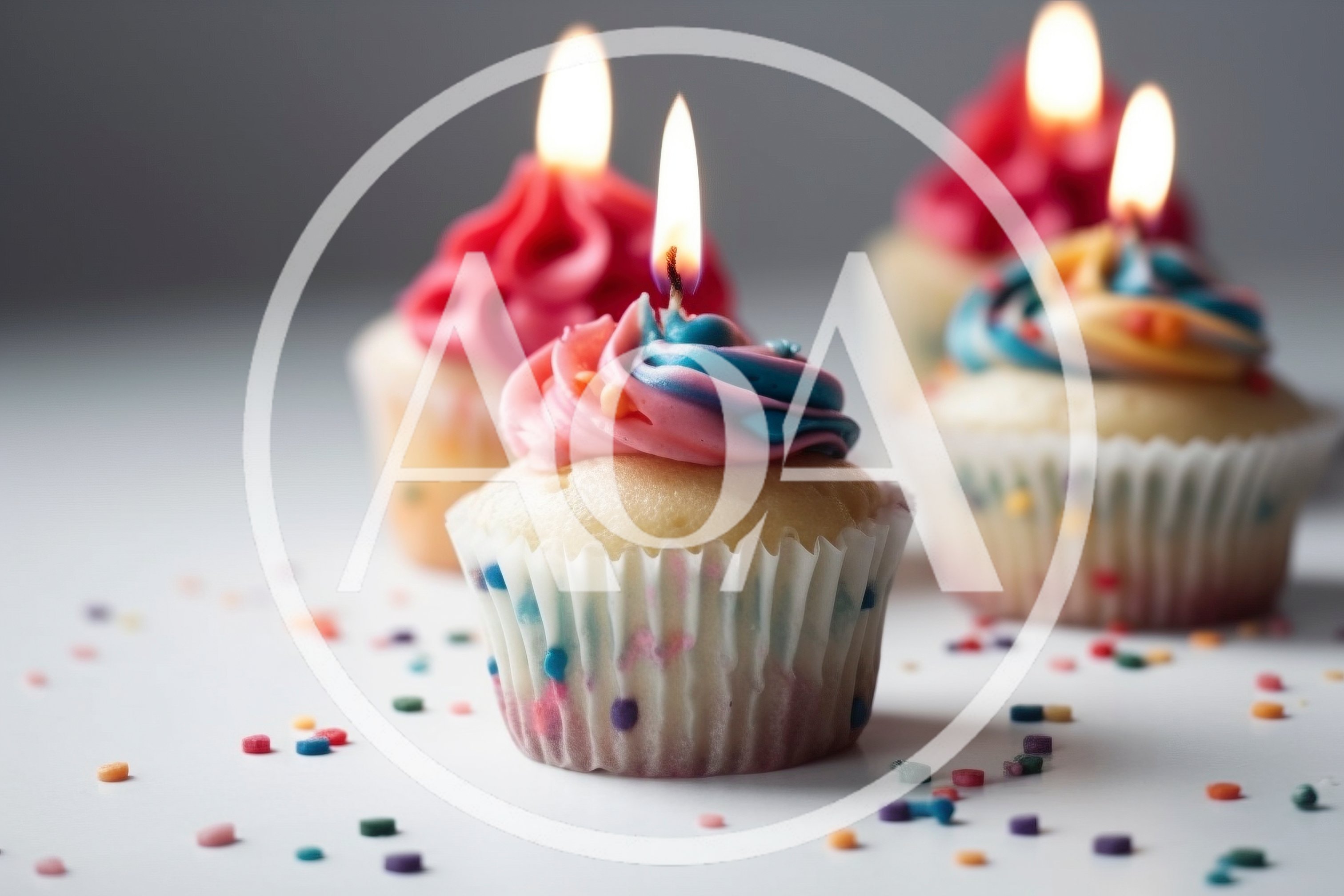 Three Festive Cupcakes With Lit Birthday Candles