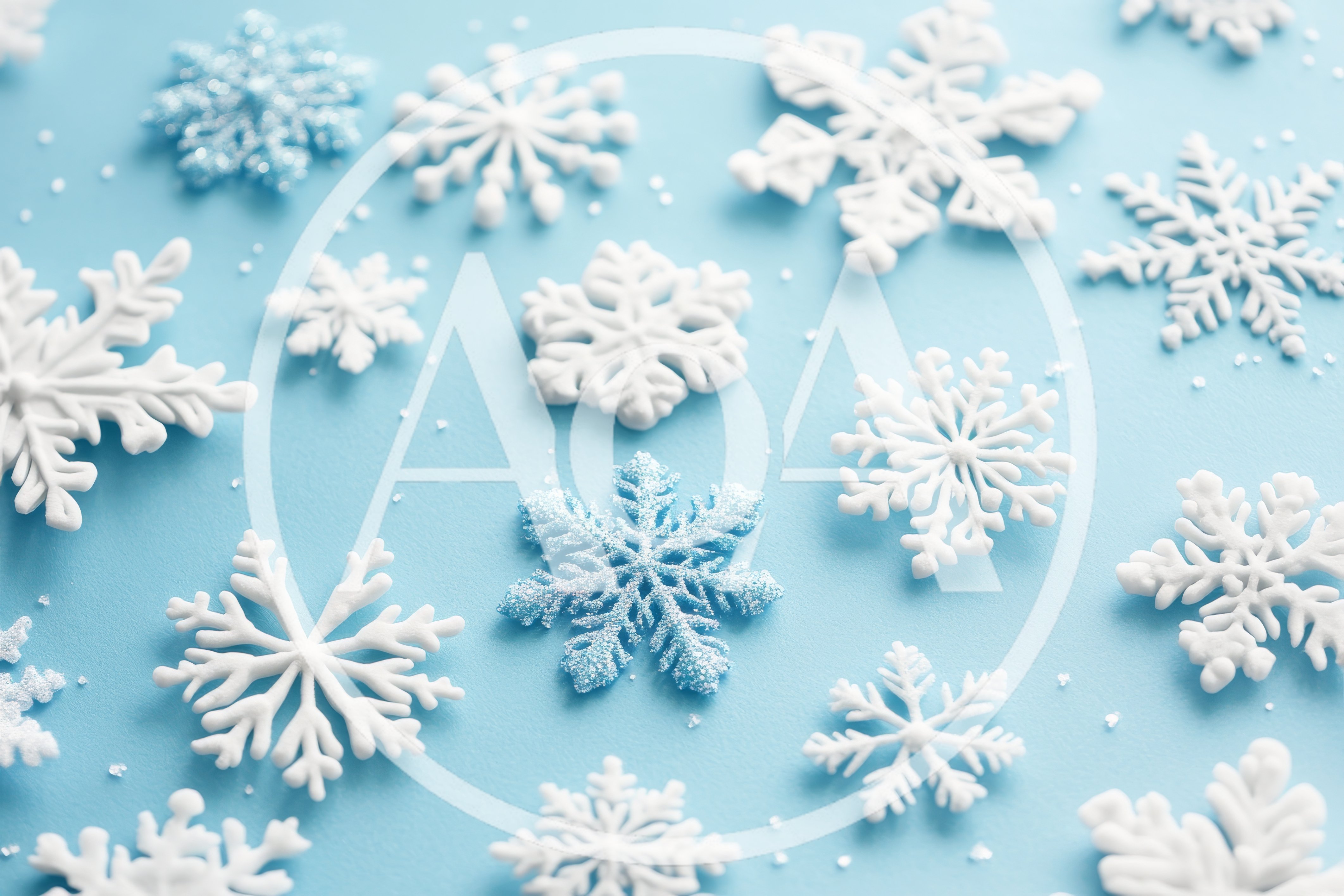 White and Blue Snowflake Ornaments on Light Blue Background