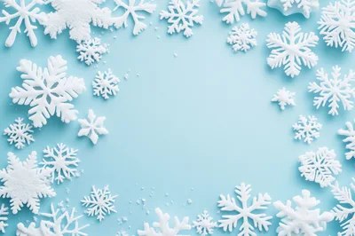 White Snowflake Ornaments Arranged on Light Blue Background