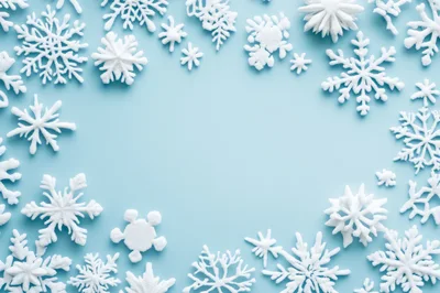 White Snowflake Ornaments Arranged On Light Blue Background