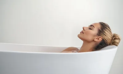 Young Woman Relaxing In A White Bathtub