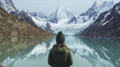 Woman Standing Before A Glacial Lake And Mountains