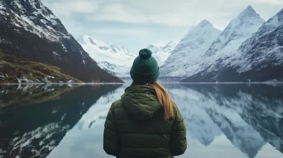 Woman Standing Before Snowy Mountains And Lake