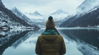 Woman Standing Before A Snowy Mountain Lake