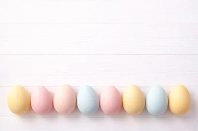 Pastel Easter Eggs Lined Up On White Wood