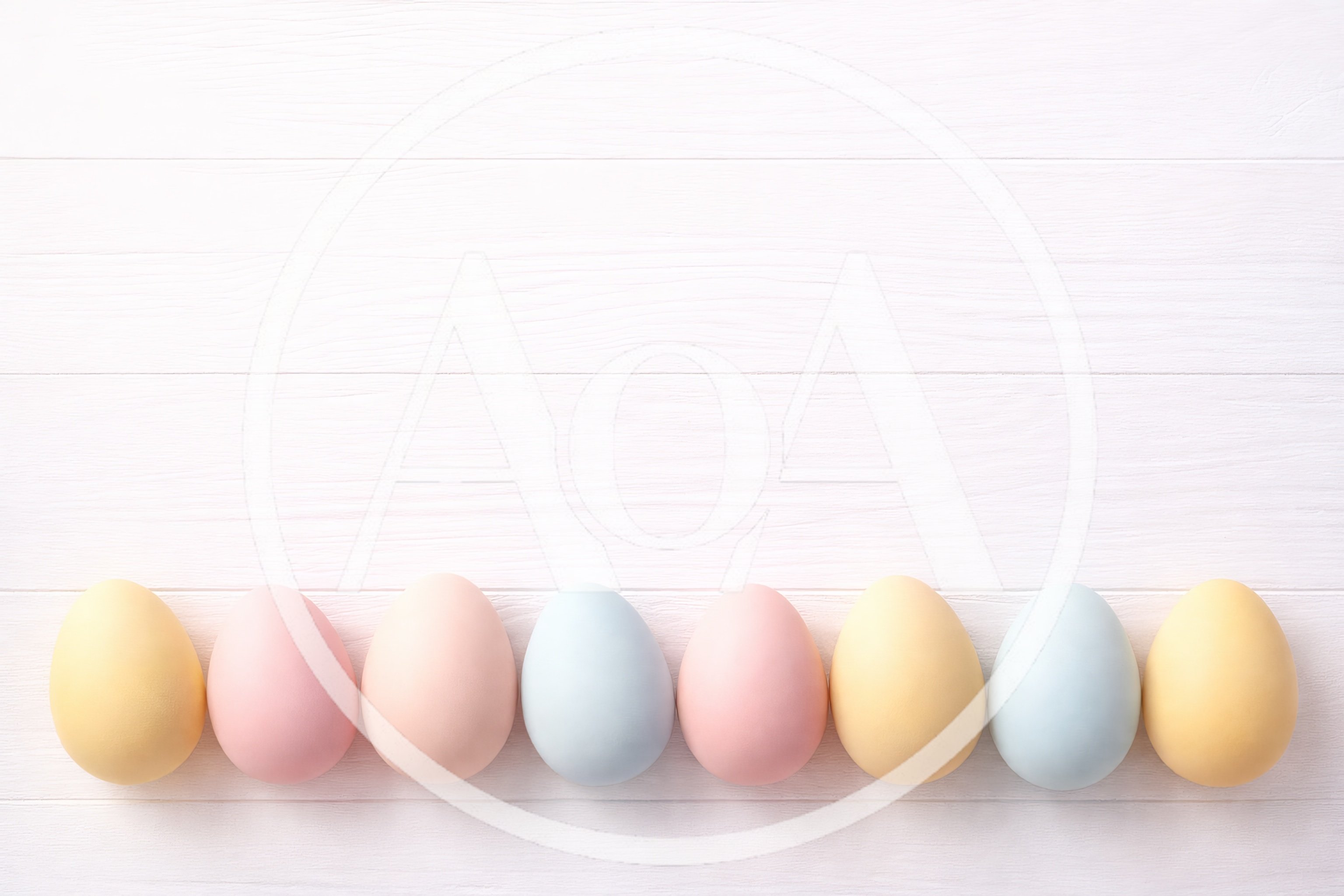 Pastel Easter Eggs Lined Up On White Wood