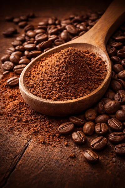Wooden Spoon Filled With Ground Coffee And Roasted Beans