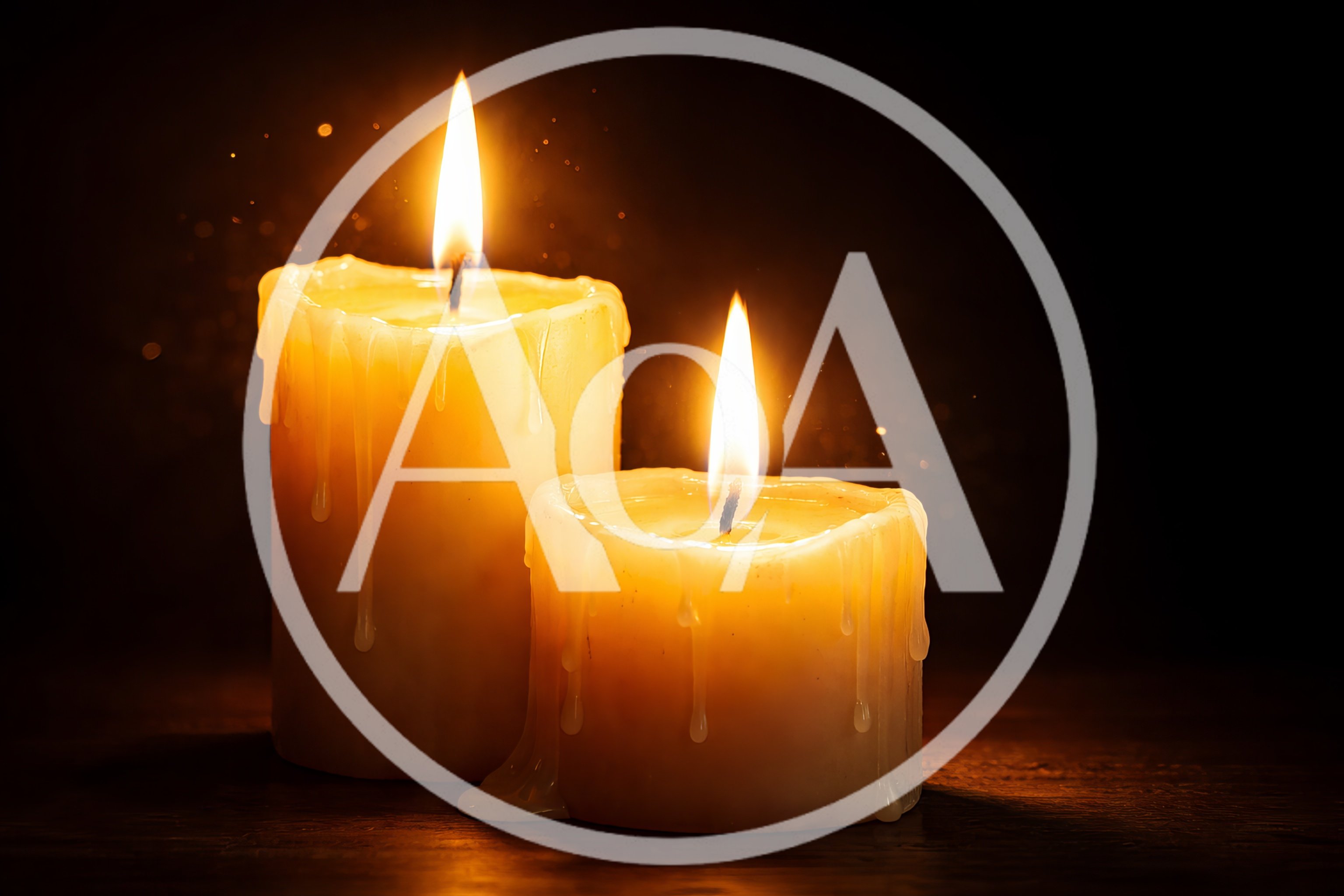 Two Lit Candles Glowing Against A Dark Background