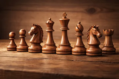 Wooden Chess Pieces Arranged In A Row