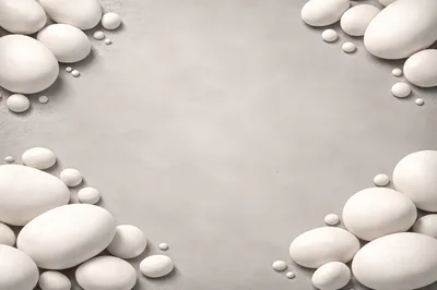 White Smooth Stones Arranged On A Grey Background