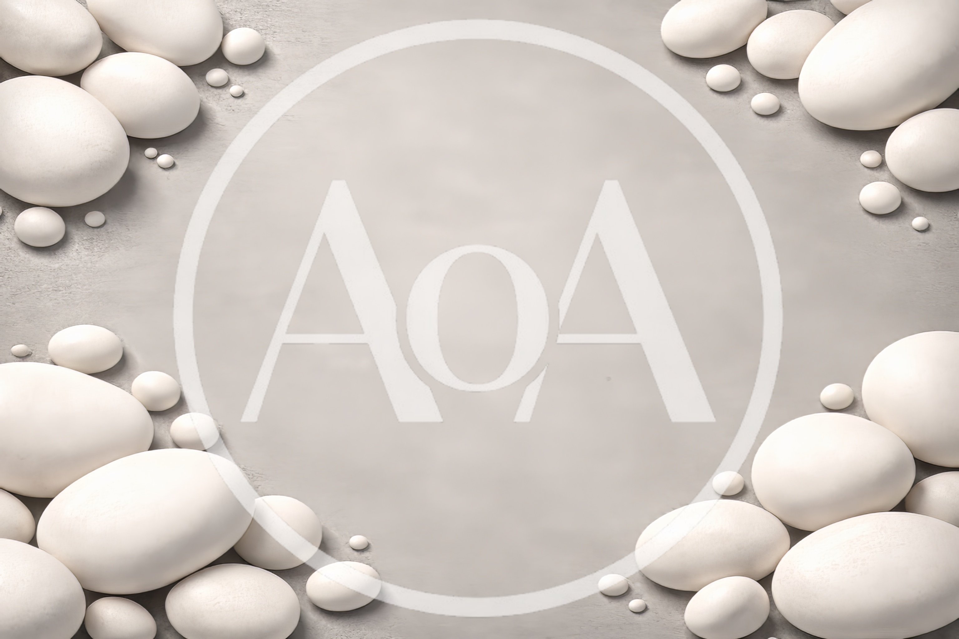 White Smooth Stones Arranged On A Grey Background