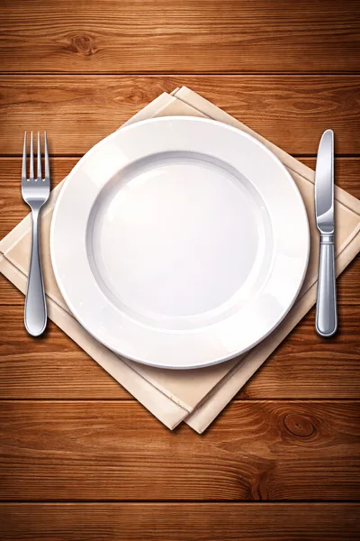 Empty White Plate With Cutlery On Wooden Table