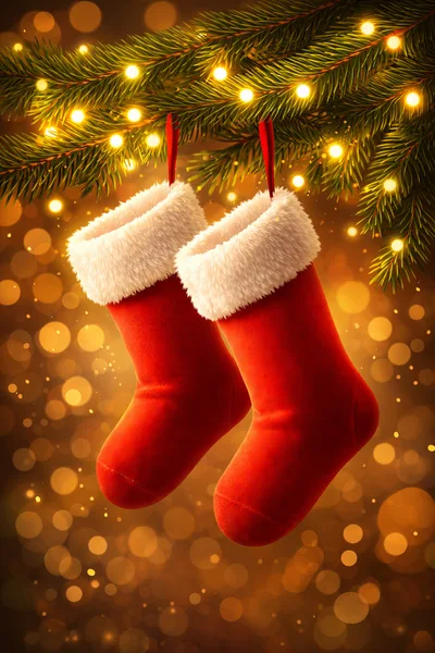 Two Red Christmas Stockings Hanging From Pine Branches