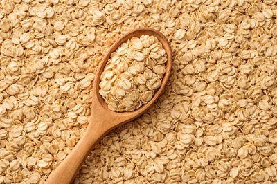 Wooden Spoon Filled With Raw Rolled Oats