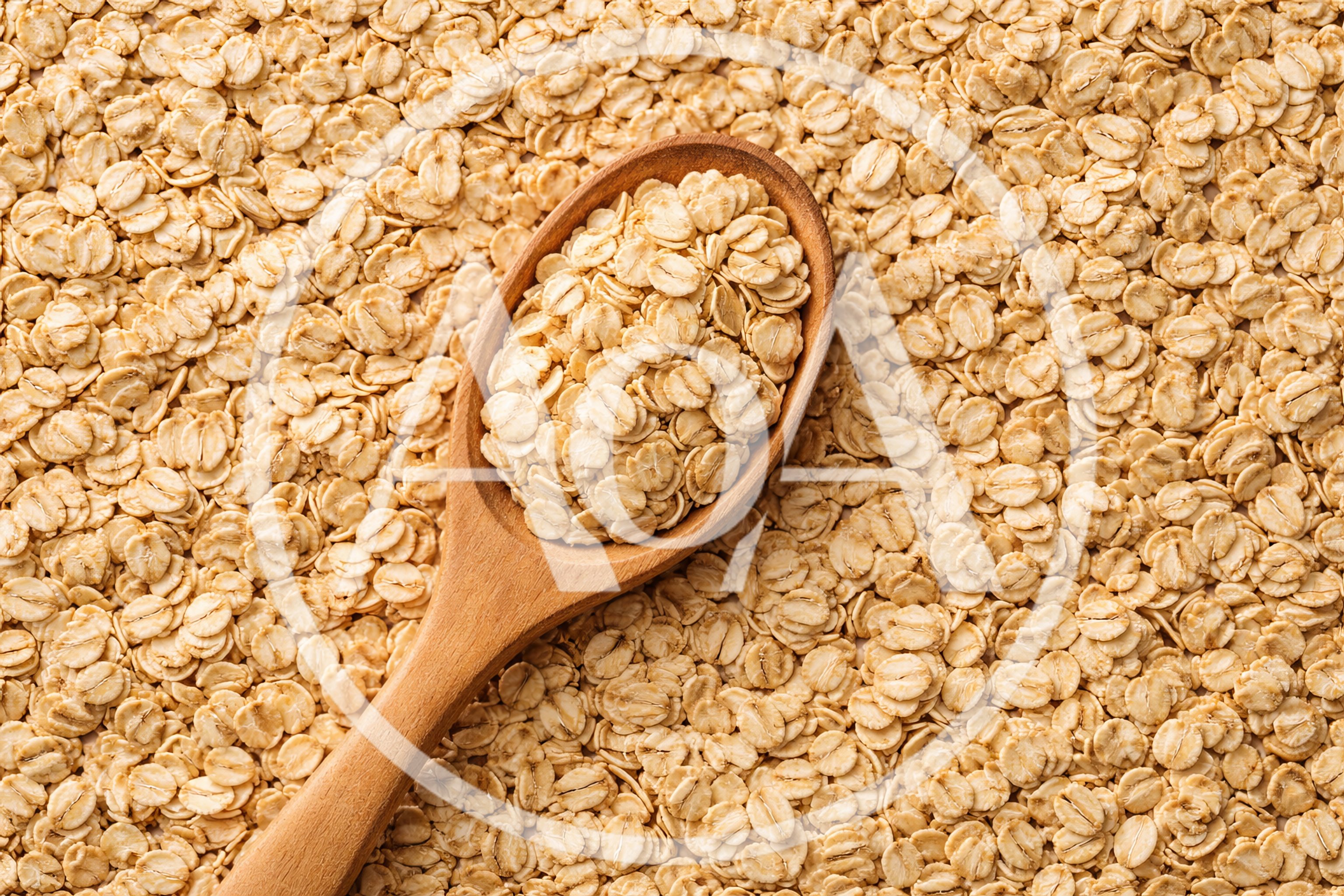 Wooden Spoon Filled With Raw Rolled Oats