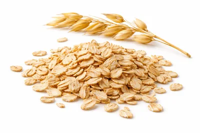 Pile of Raw Rolled Oats with Oat Stalk
