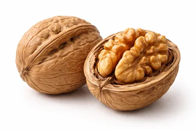 Whole And Cracked Walnuts On White Background