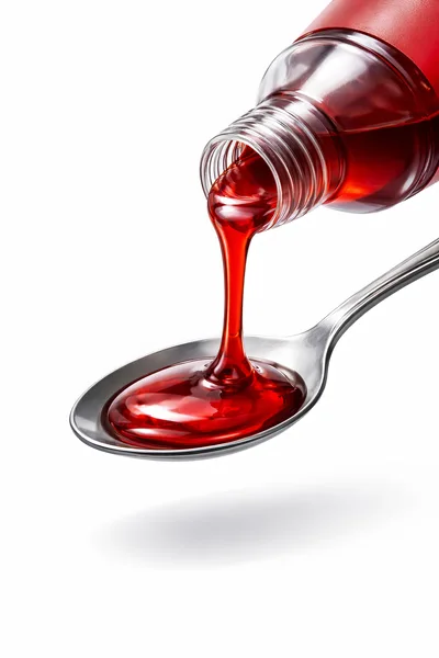 Red Cough Syrup Pouring Into A Metal Spoon