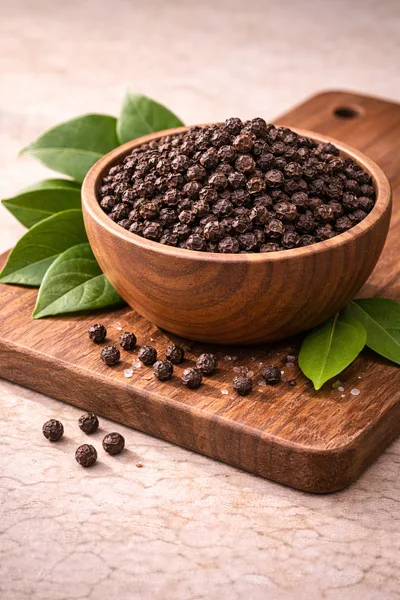 Wooden Bowl Filled With Whole Black Peppercorns