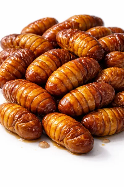 Pile Of Cooked Silkworm Pupae On White Background