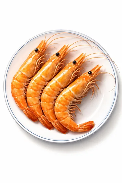 Four Cooked Whole Shrimp Arranged On A White Plate