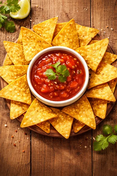 Tortilla Chips With Salsa Dip On Wooden Board