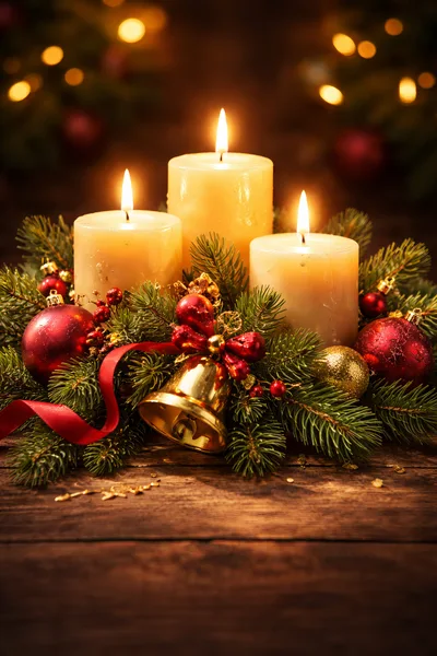 Three Lit Christmas Candles With Festive Decorations