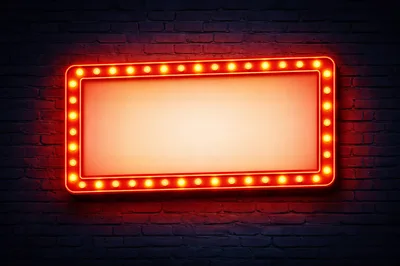 Illuminated Rectangular Marquee Sign On Dark Brick Wall