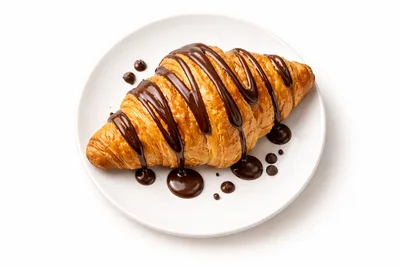 Fresh Croissant Drizzled With Rich Chocolate Sauce