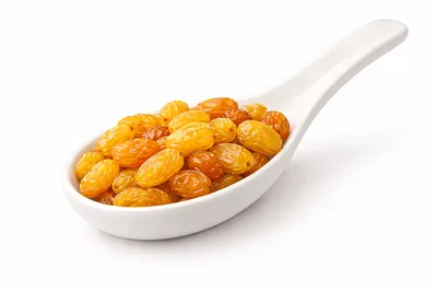 Golden Raisins in a White Ceramic Spoon