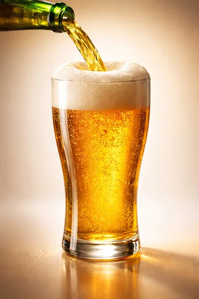 Golden Beer Pouring Into A Glass
