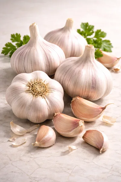 Fresh Garlic Bulbs and Cloves on Marble Surface