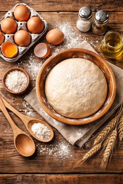 Fresh Dough Preparation With Ingredients On Rustic Wood