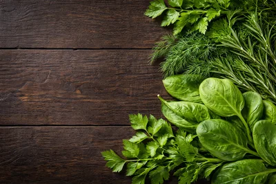 Fresh Green Herbs And Spinach On Wooden Background