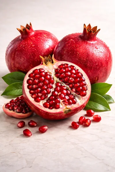 Fresh Whole And Cut Pomegranates With Seeds