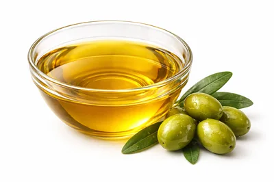 Glass Bowl Of Golden Olive Oil With Fresh Olives