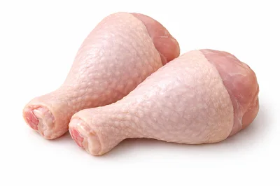 Two Raw Chicken Drumsticks on White Background