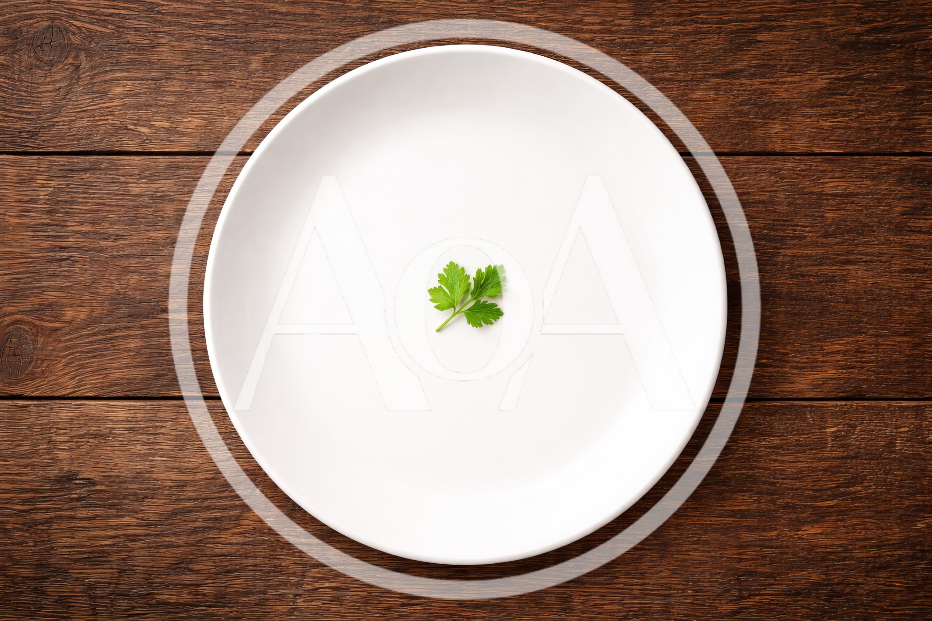 Single Parsley Sprig Centered on a White Plate