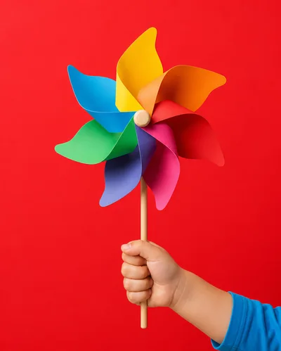Child Holding A Colorful Pinwheel Toy