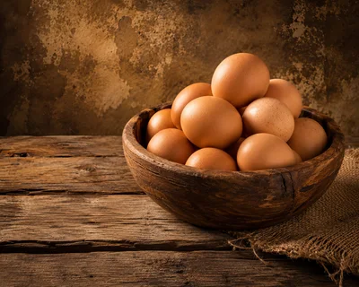 Fresh Brown Eggs In A Rustic Wooden Bowl