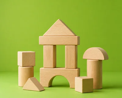 Wooden Building Blocks Arranged on Green Background