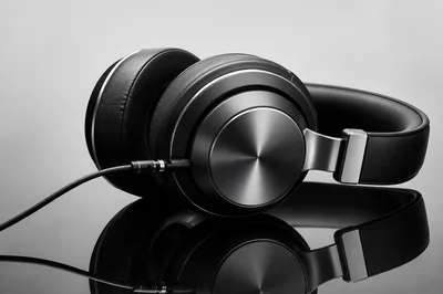 Professional Studio Headphones With Audio Cable On Reflective Surface
