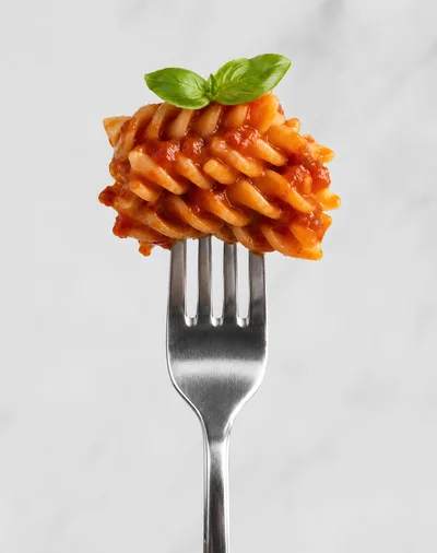 Fusilli Pasta With Tomato Sauce On A Fork