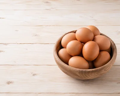 Fresh Brown Eggs In A Wooden Bowl